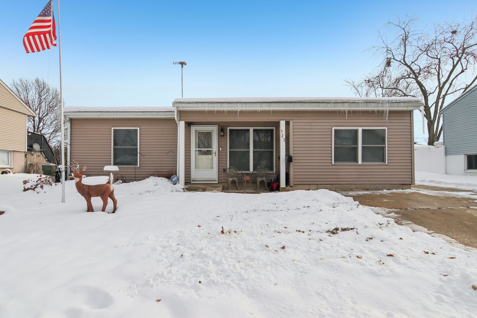 327 Hickory Avenue Romeoville, IL 60446 - Photo 1 of 33 a view of a house with a snow in the middle of a yard