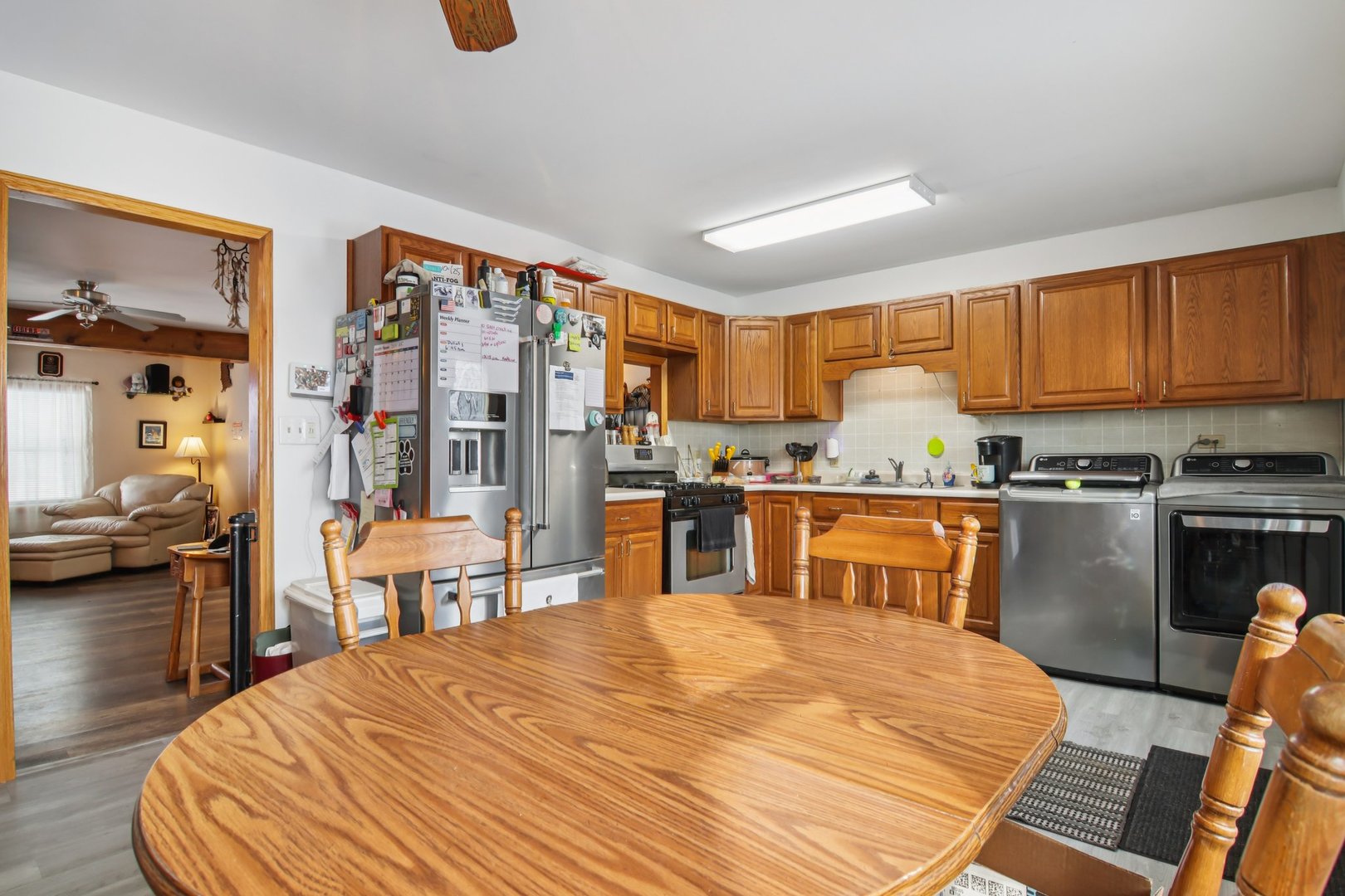 327 Hickory Avenue Romeoville, IL 60446 - Photo 13 of 33 a kitchen with stainless steel appliances kitchen island granite countertop a refrigerator a stove top oven and a sink with dishwasher