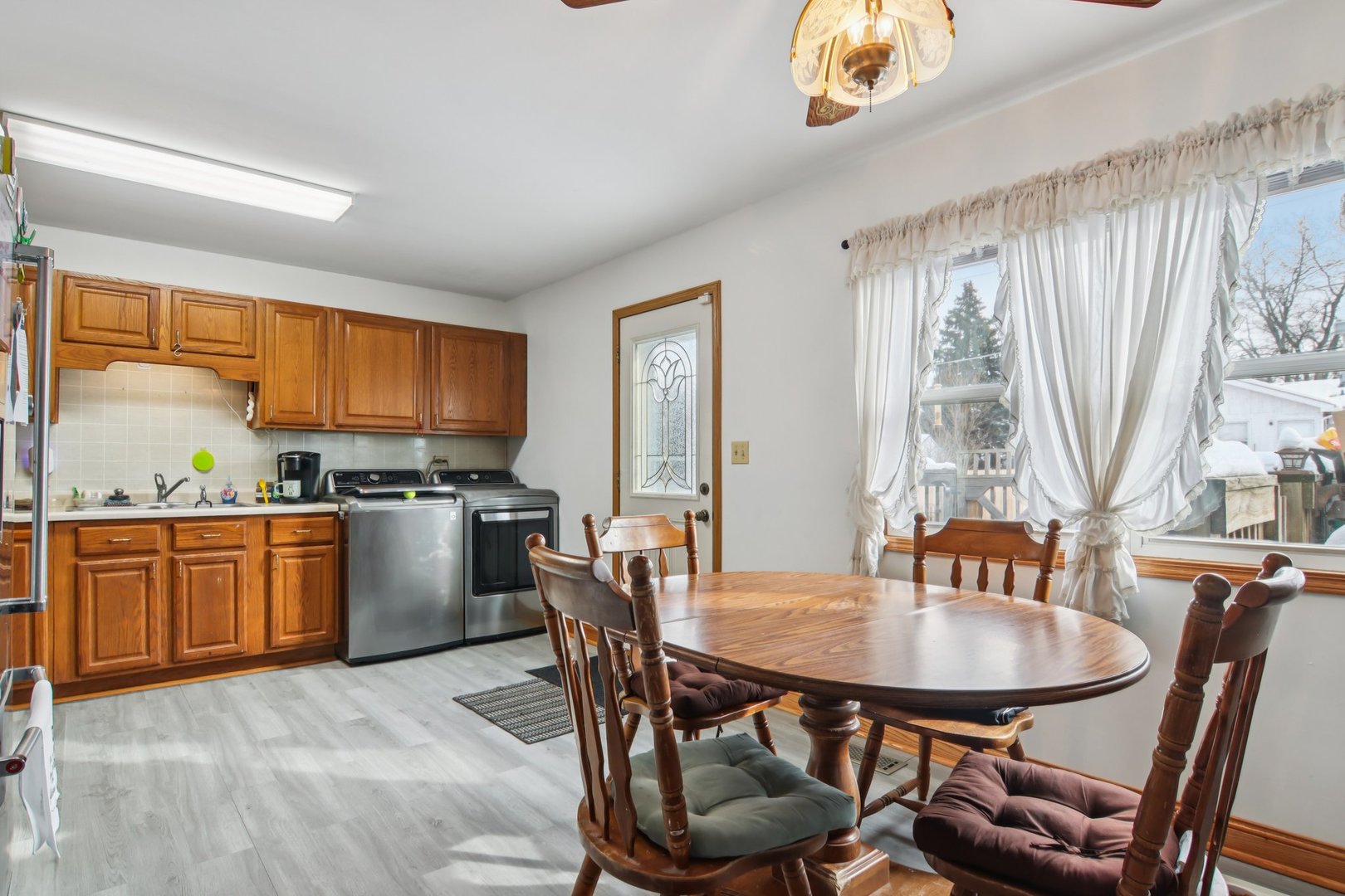 327 Hickory Avenue Romeoville, IL 60446 - Photo 14 of 33 a kitchen with a table chairs sink and cabinets