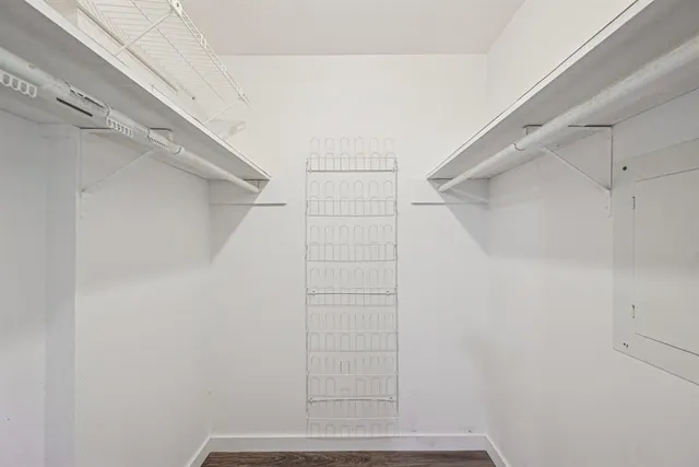 a white toilet sitting next to a white wall