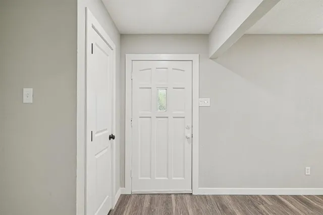 a view of a hallway with wooden floor