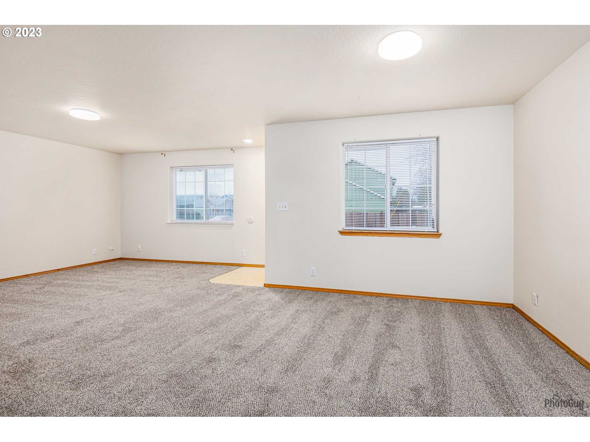 499 South 41st Street Springfield, OR 97478 - Photo 10 of 26 a view of an empty room with wooden floor and a window