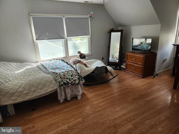 a bedroom with a bed window and dresser