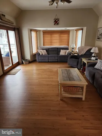 a living room with furniture window and wooden floor