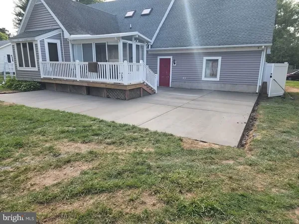 a view of a house with a yard and sitting area