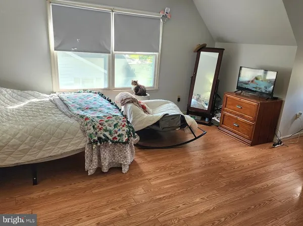 a bedroom with a bed window and a dresser