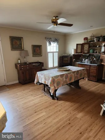 a large bedroom with a bed and wooden floor