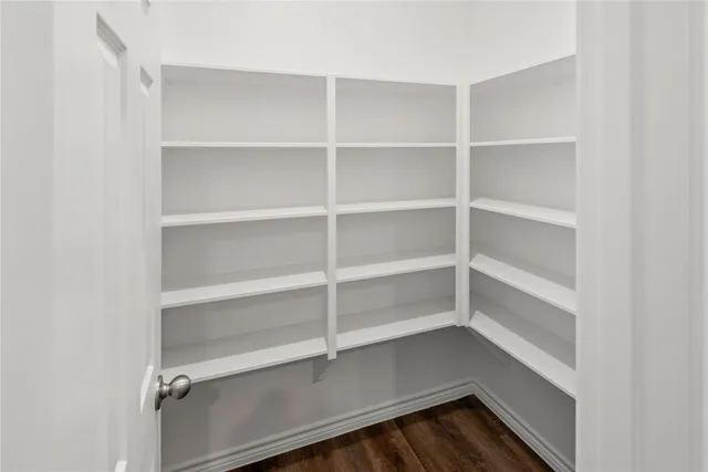 a view of walk in closet with empty racks