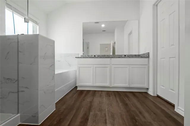 a view of walk in closet with wooden floor