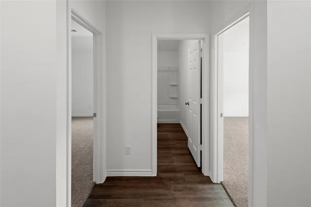 a view of a hallway with the wooden floor