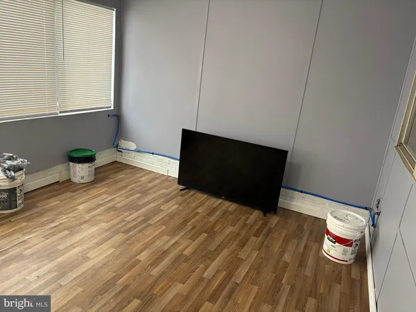 a bedroom with a bed and a potted plant