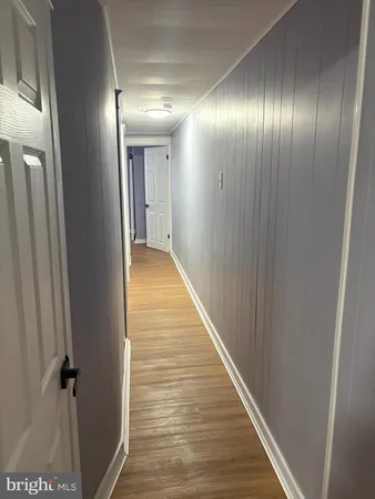 a view of hallway with wooden floor