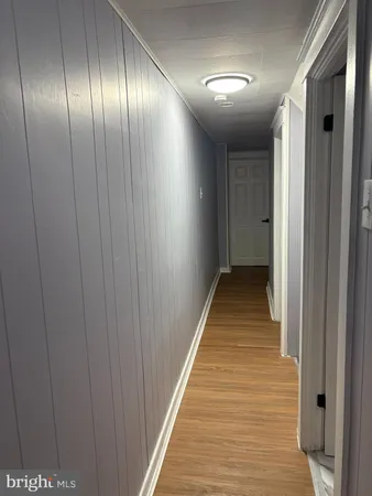 a view of hallway with wooden floor