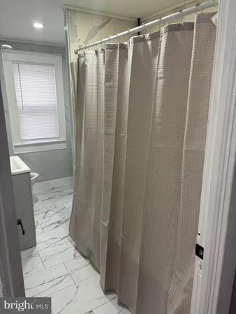 a bathroom with a shower and a toilet