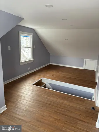a view of wooden floor and windows in a room