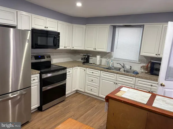 a kitchen with a refrigerator stove and microwave