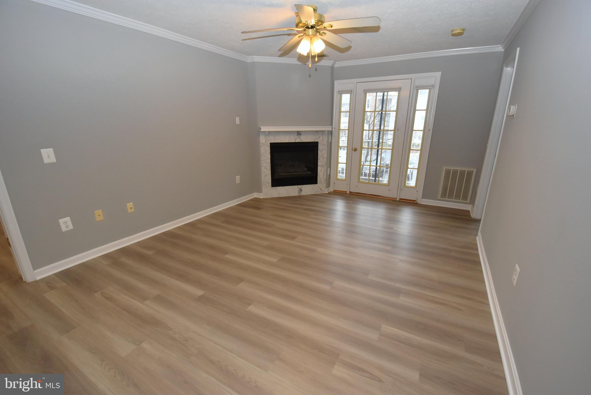 2002 Phillips Terrace, Unit 6 Annapolis, MD 21401 - Photo 4 of 17 wooden floor in an empty room with a window