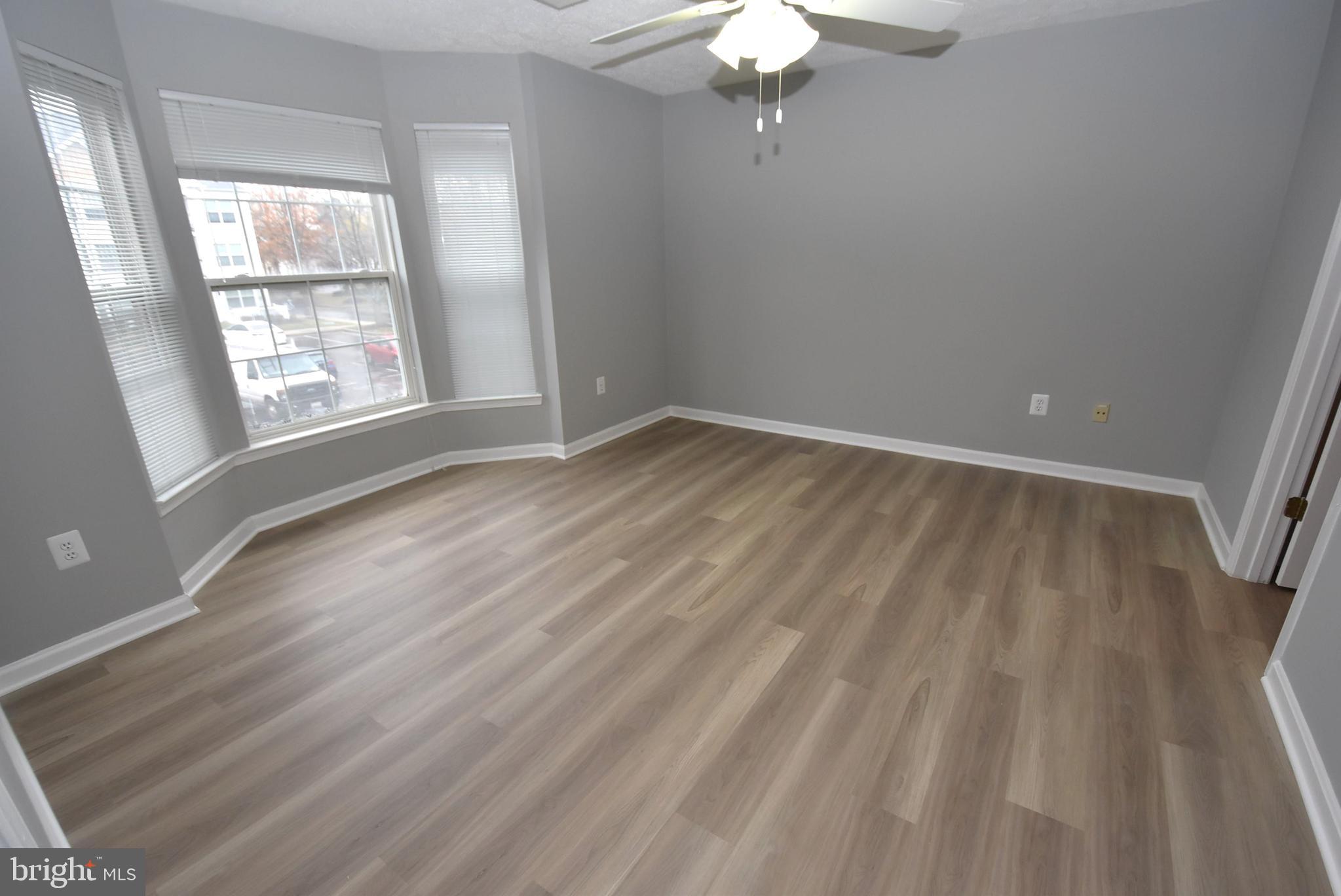 2002 Phillips Terrace, Unit 6 Annapolis, MD 21401 - Photo 5 of 17 wooden floor in an empty room with a window