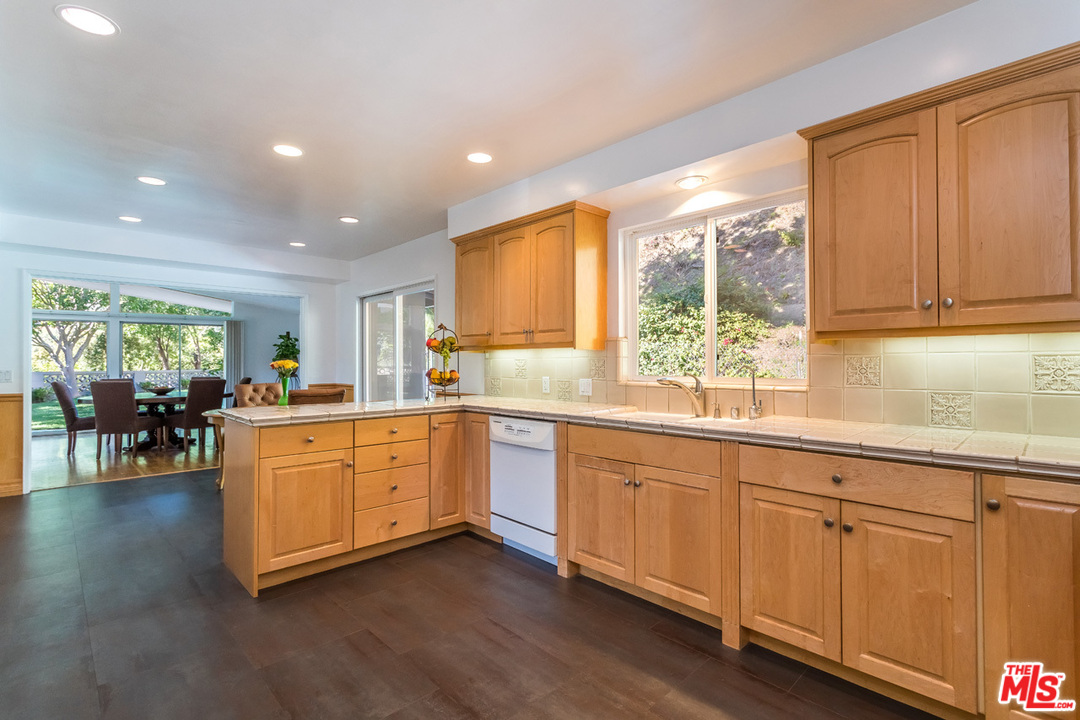 9767 Beth Place Beverly Hills, CA 90210 - Photo 13 of 33 a large kitchen with kitchen island granite countertop a large window a sink and stainless steel appliances