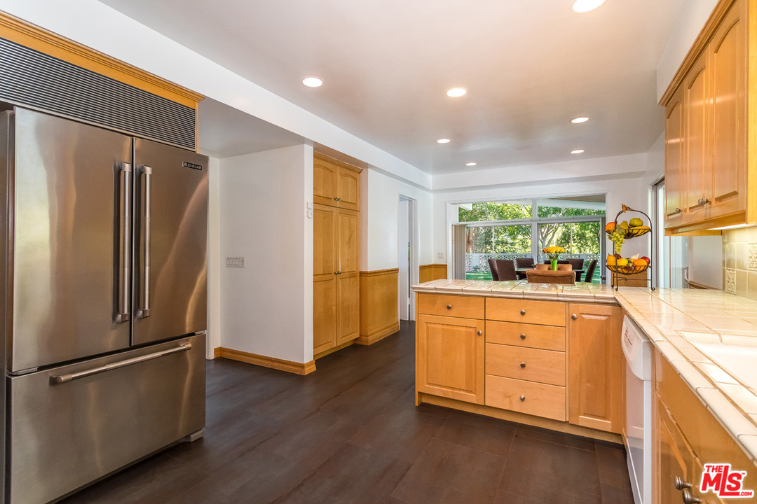 9767 Beth Place Beverly Hills, CA 90210 - Photo 15 of 33 a kitchen with stainless steel appliances a refrigerator and a sink