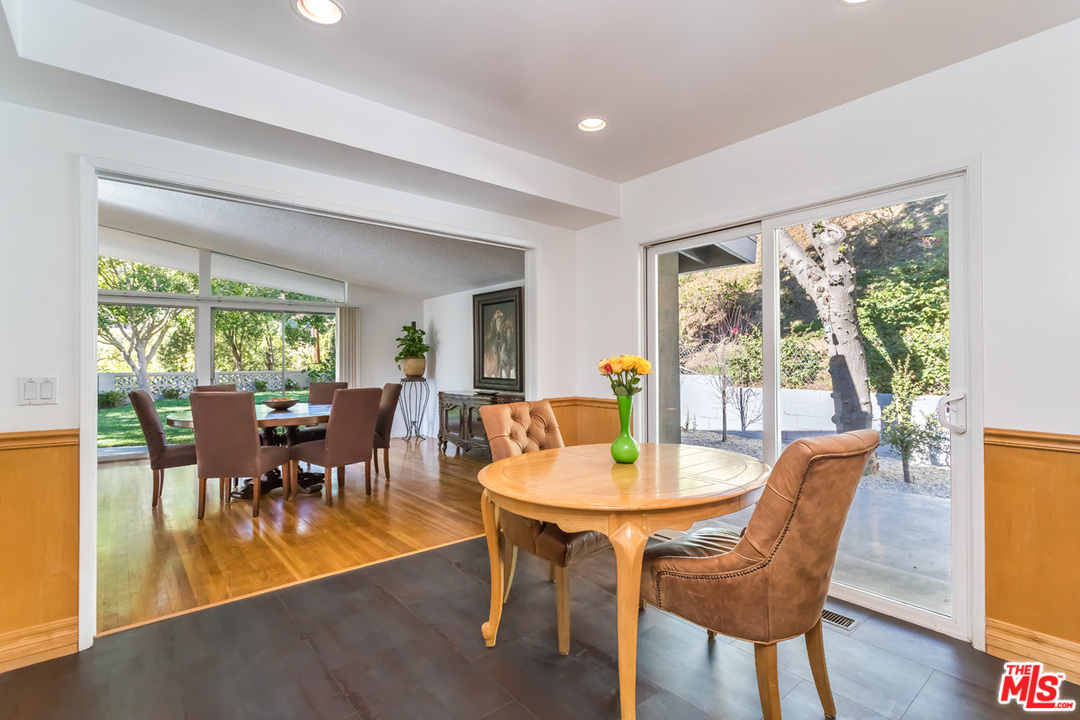 9767 Beth Place Beverly Hills, CA 90210 - Photo 17 of 33 a dining room with furniture a chandelier and wooden floor