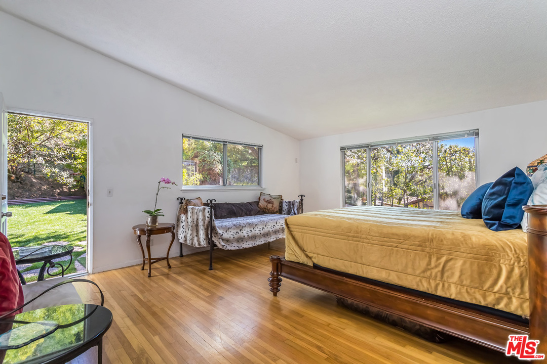 9767 Beth Place Beverly Hills, CA 90210 - Photo 19 of 33 a bed room with a bed and a chair