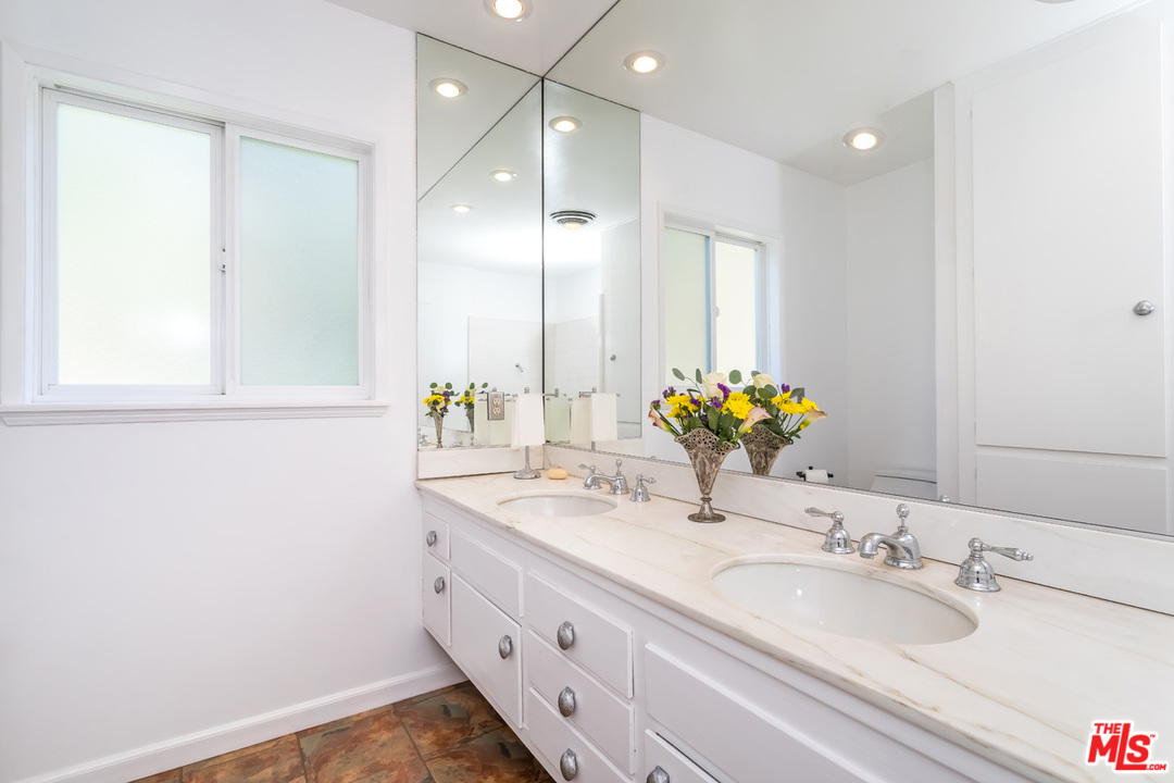 9767 Beth Place Beverly Hills, CA 90210 - Photo 21 of 33 a bathroom with a sink double vanity and a mirror