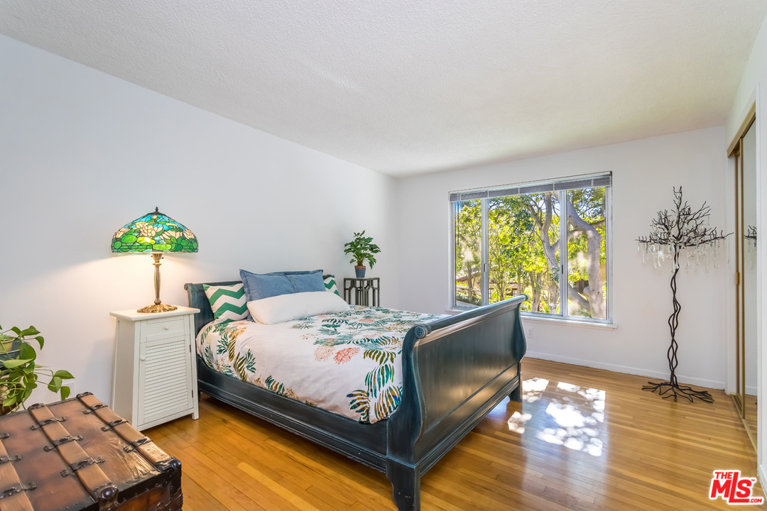 9767 Beth Place Beverly Hills, CA 90210 - Photo 22 of 33 a bed sitting in a bedroom next to a window