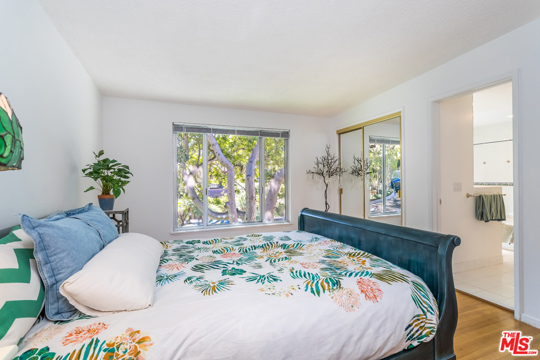 9767 Beth Place Beverly Hills, CA 90210 - Photo 27 of 33 a bedroom with a bed and a chair