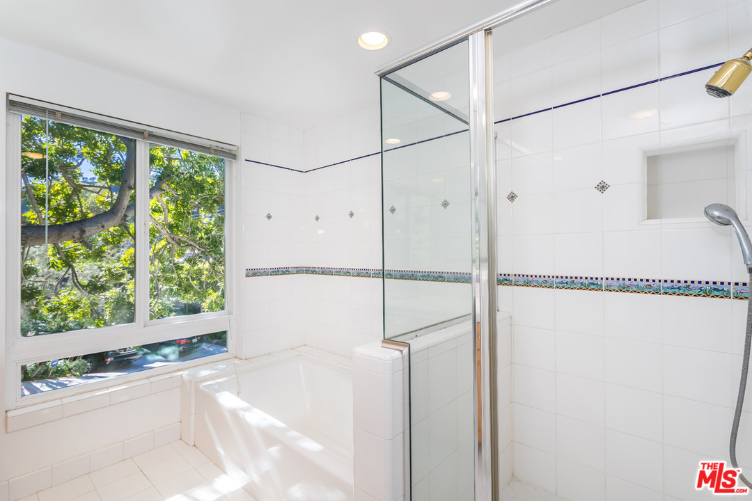 9767 Beth Place Beverly Hills, CA 90210 - Photo 28 of 33 a bathroom with a shower and a window