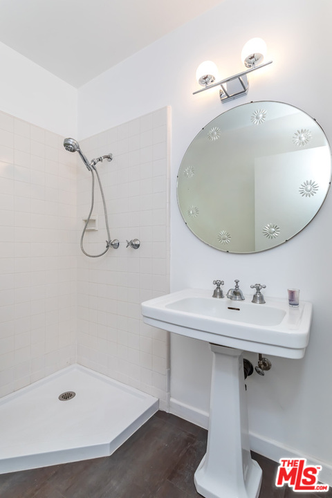 9767 Beth Place Beverly Hills, CA 90210 - Photo 30 of 33 a bathroom with a sink a mirror and a bathtub