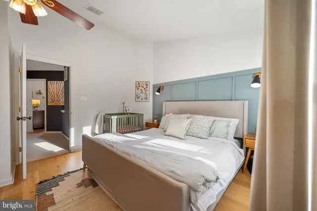 a bed sitting in a bedroom next to a window