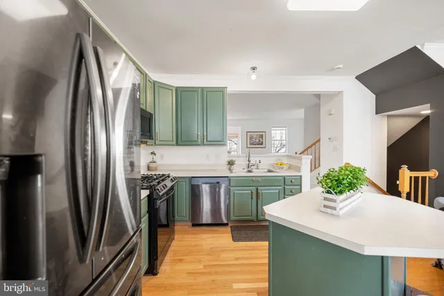 a kitchen with stainless steel appliances a sink stove and refrigerator