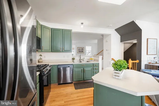 a kitchen with stainless steel appliances granite countertop a sink and a stove