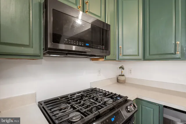 a kitchen with a stove and a microwave