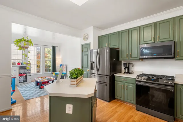 a kitchen with stainless steel appliances a stove refrigerator sink and microwave