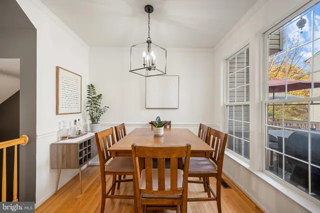 a view of a dining room with furniture wooden floor and chandelier