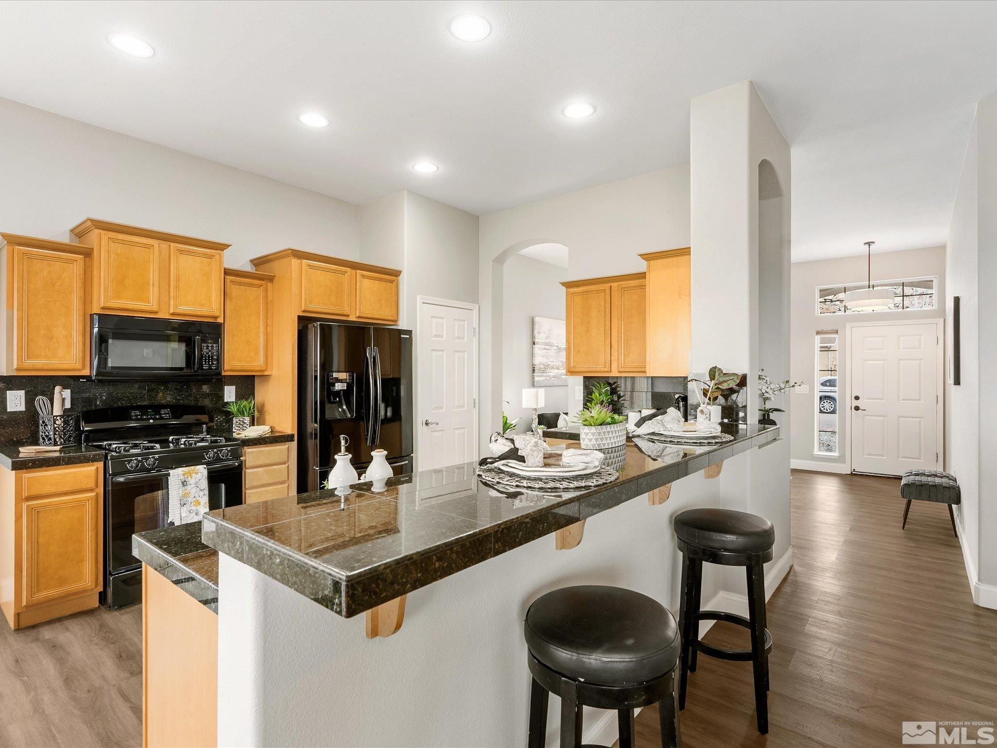 1448 Hagar Road Reno, NV 89506 - Photo 12 of 38 a kitchen with sink refrigerator and dining table