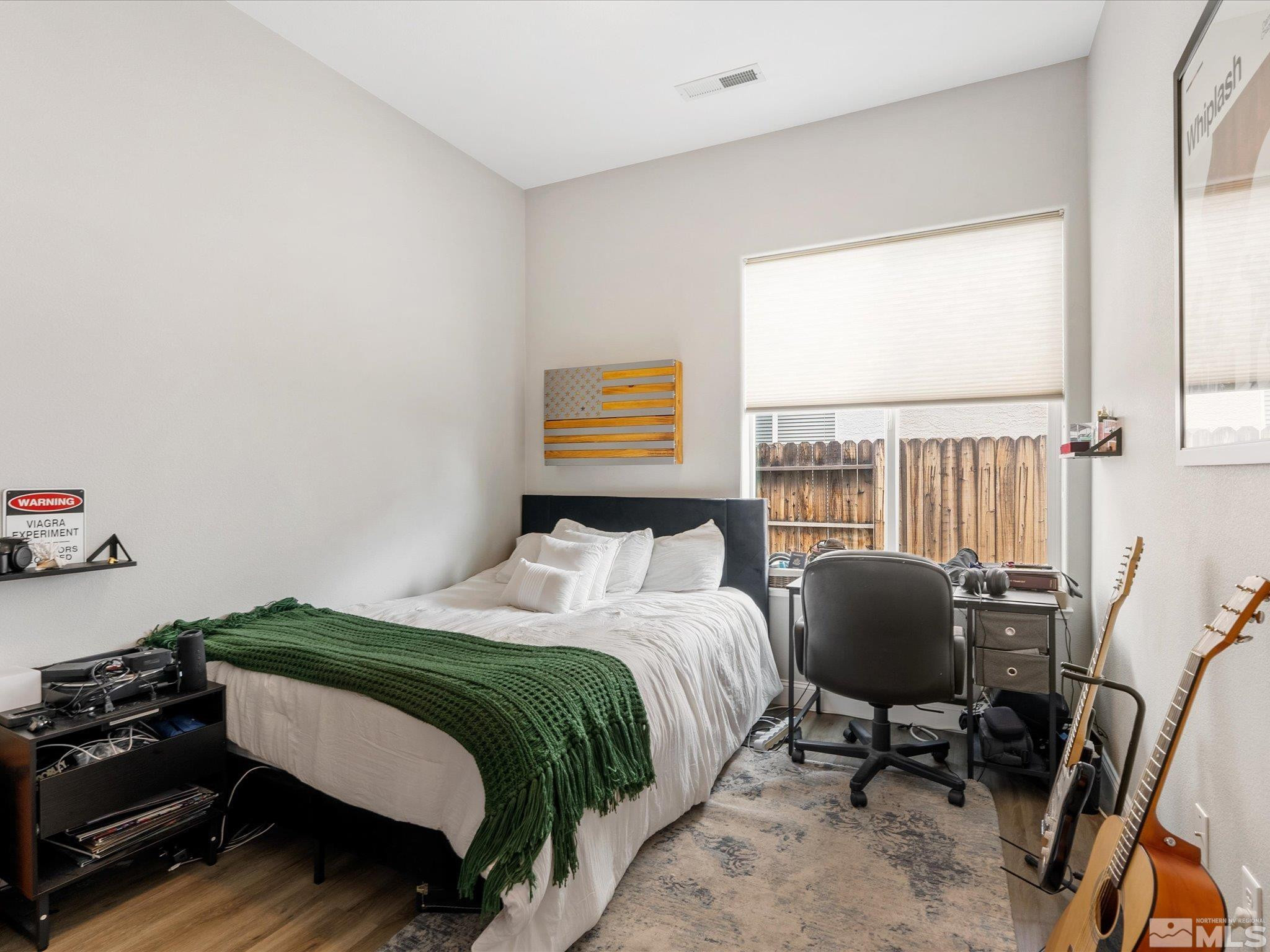 1448 Hagar Road Reno, NV 89506 - Photo 19 of 38 a bedroom with a bed chair and a window