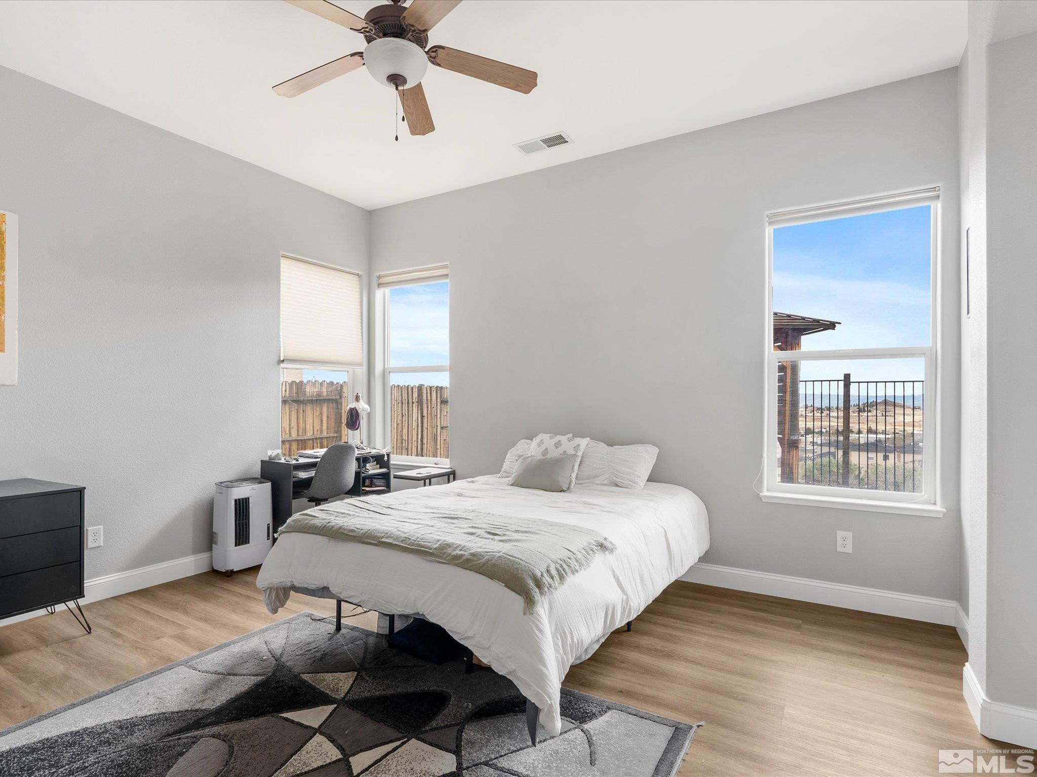1448 Hagar Road Reno, NV 89506 - Photo 21 of 38 a bedroom with a bed and wooden floor