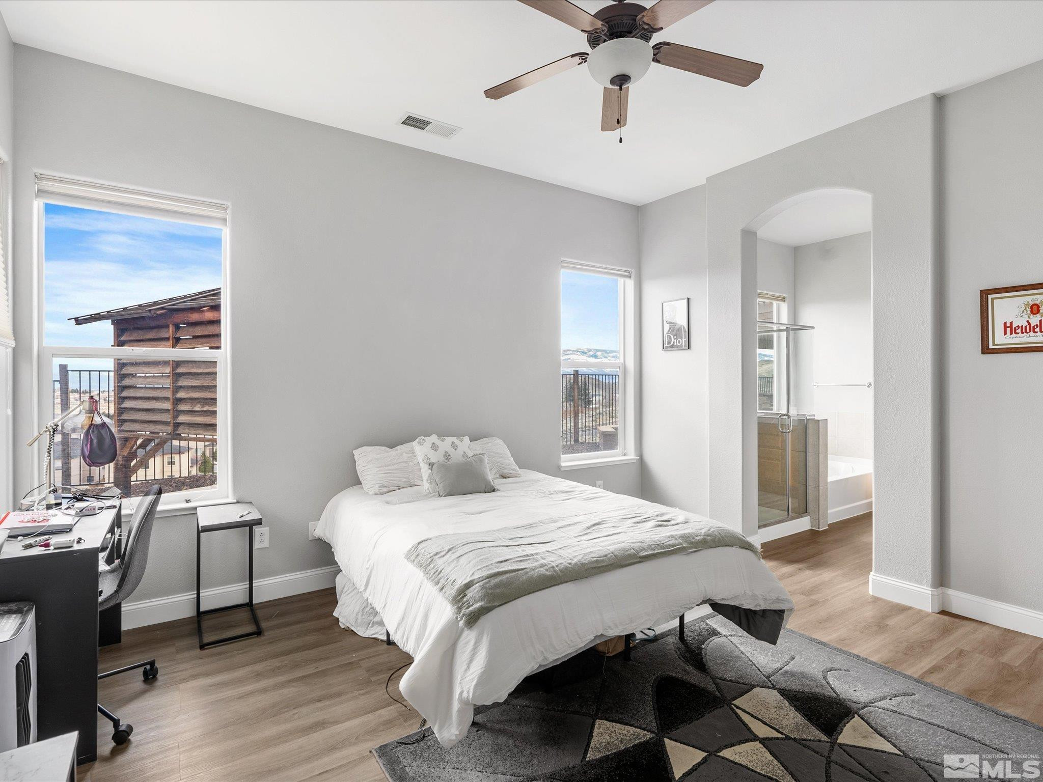1448 Hagar Road Reno, NV 89506 - Photo 22 of 38 a bedroom with a bed and a chandelier