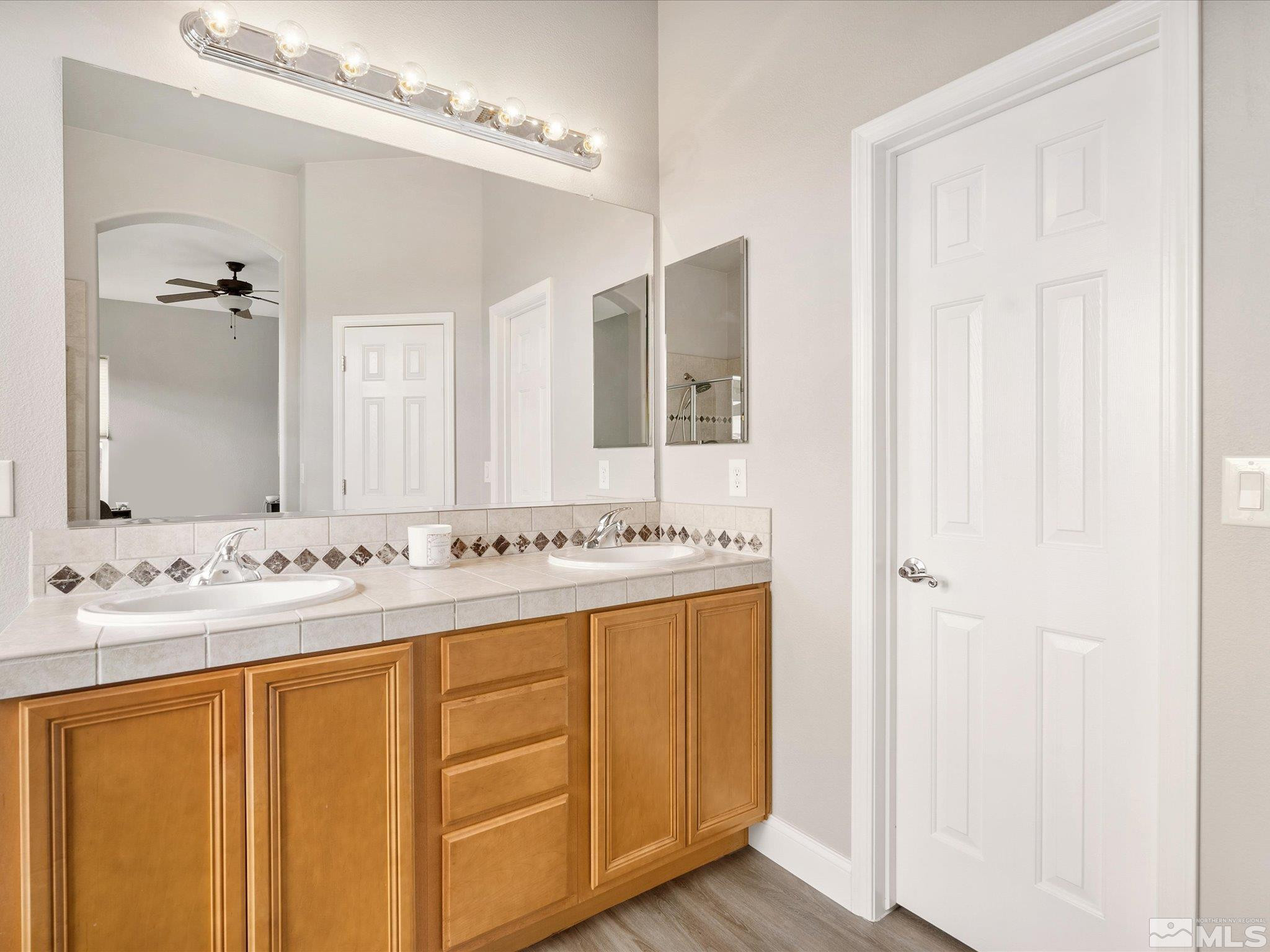 1448 Hagar Road Reno, NV 89506 - Photo 24 of 38 a bathroom with a sink and a mirror