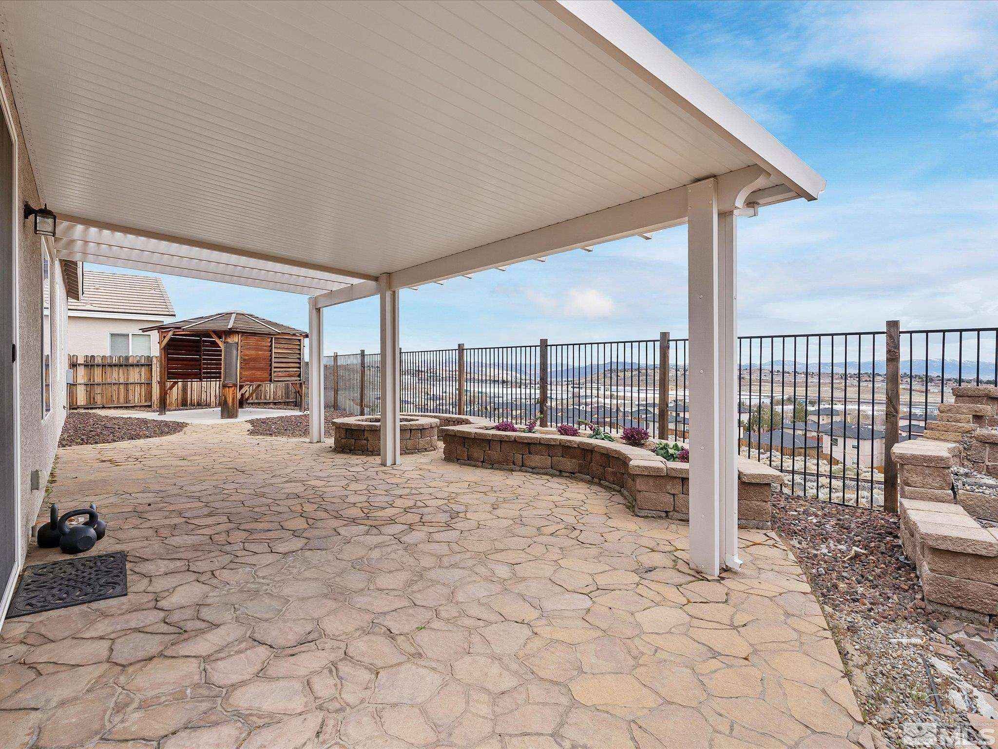 1448 Hagar Road Reno, NV 89506 - Photo 26 of 38 a view of a balcony with chairs and iron fence