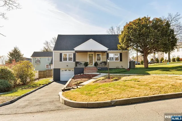 a view of a house with swimming pool and sitting area