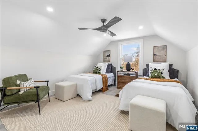 a spacious bedroom with two beds and a couch