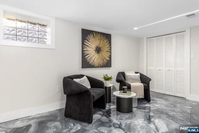 a living room with furniture and floor to ceiling window