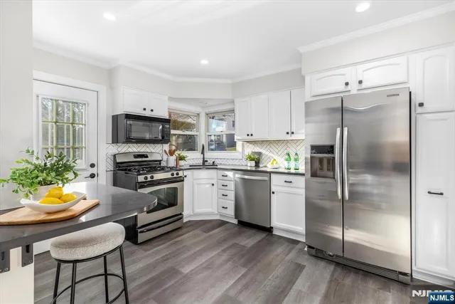 a kitchen with a refrigerator stove and microwave