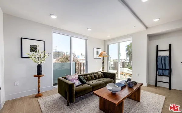 a living room with furniture and large window