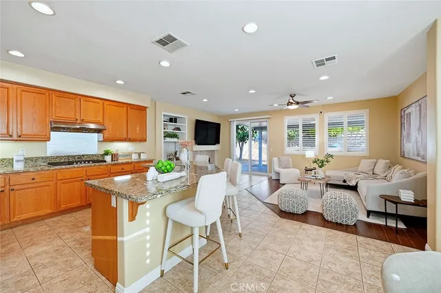 a living room with granite countertop furniture and kitchen view