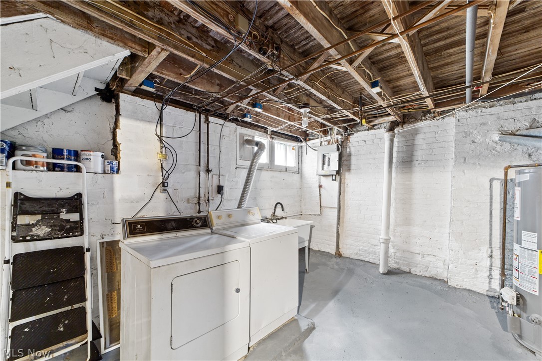 3076 Yorkshire Road Cleveland, OH 44118 - Photo 13 of 47 Basement featuring sink, separate washer and dryer, and gas water heater